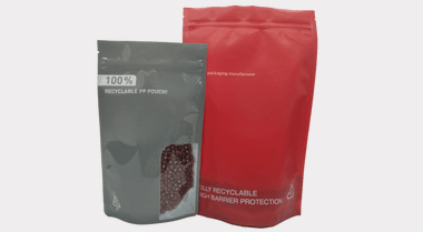 Recyclable stand up pouch with custom-shaped clear window showing nuts inside, flush window edge highlighted