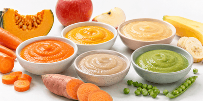 Colorful baby food flat bottom spout pouches in fruit puree flavors on a nursery shelf